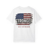A white short-sleeve crewneck t-shirt featuring a distressed American flag graphic on the chest with the word 'STRONGER' in bold white letters and the phrase 'BUILT ON FREEDOM' printed below in red.